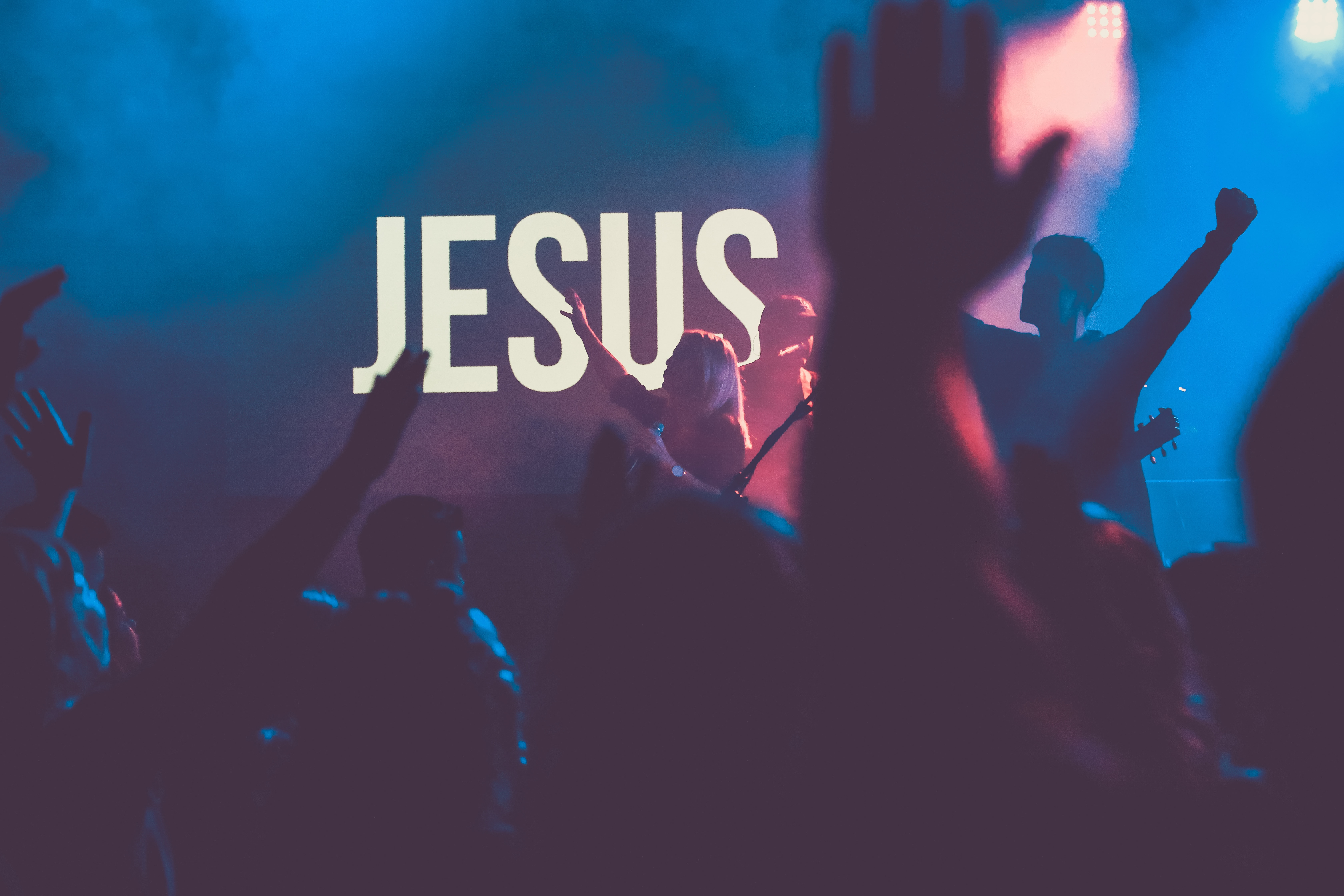 Jesus on a screen with people worshiping