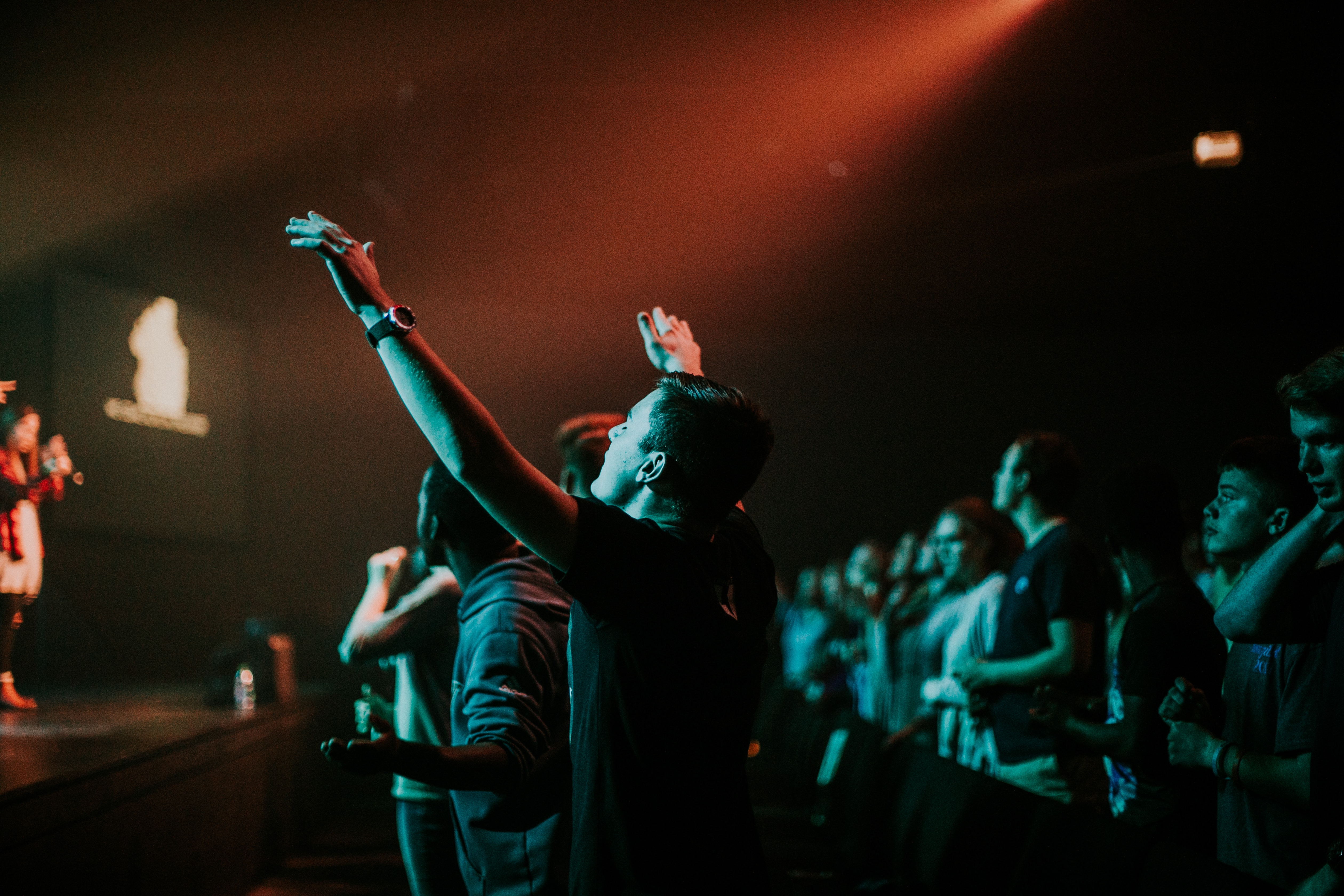man with hands raised in worship